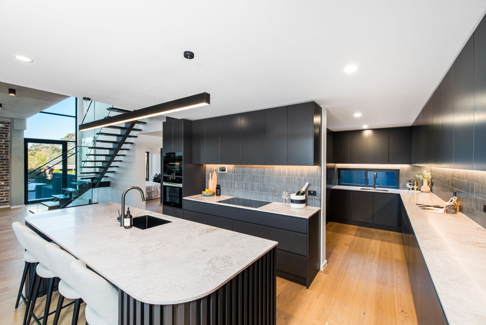 Kitchen beneath the floating staircase