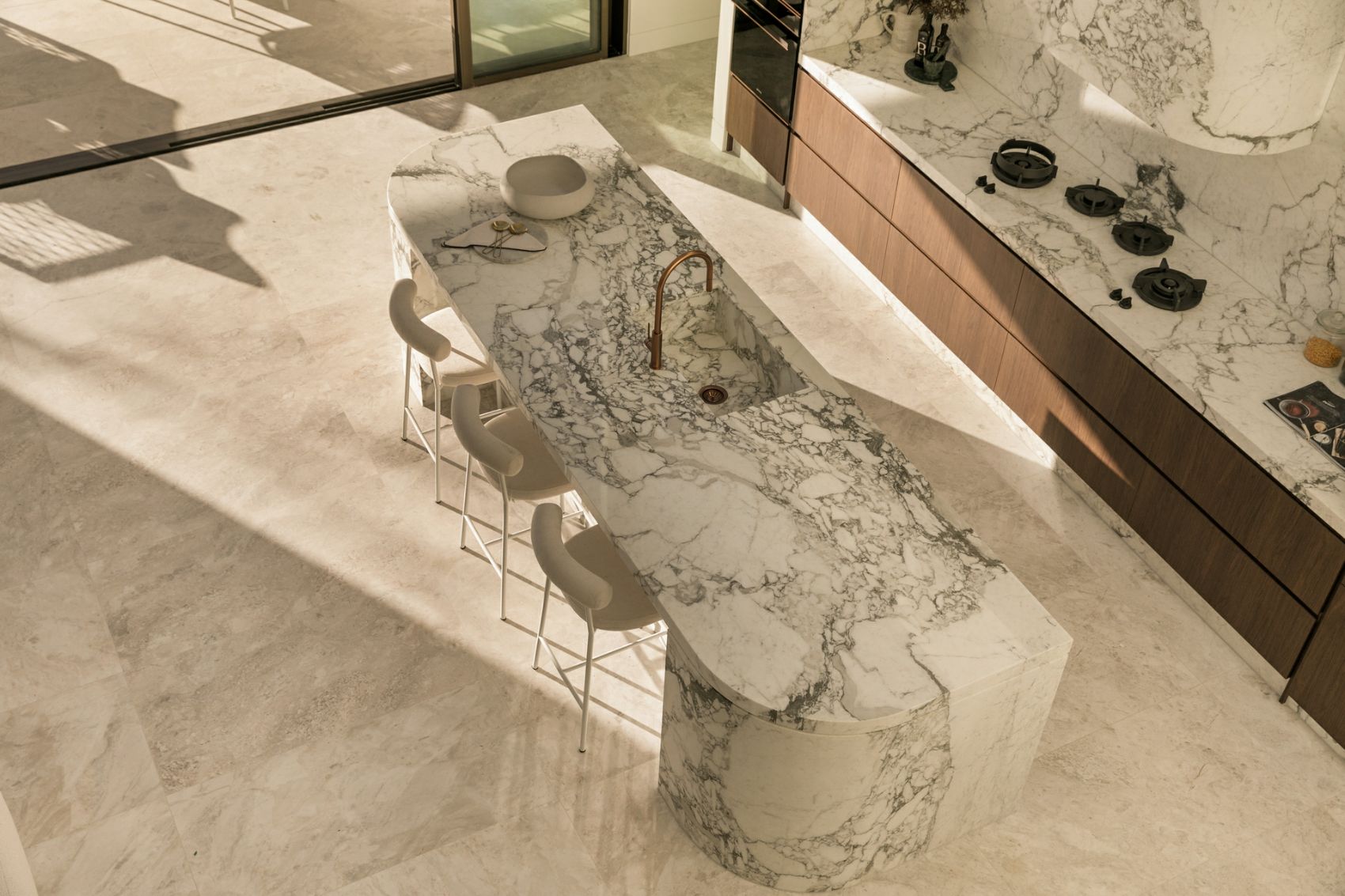 Book-matched Arabescato marble kitchen island